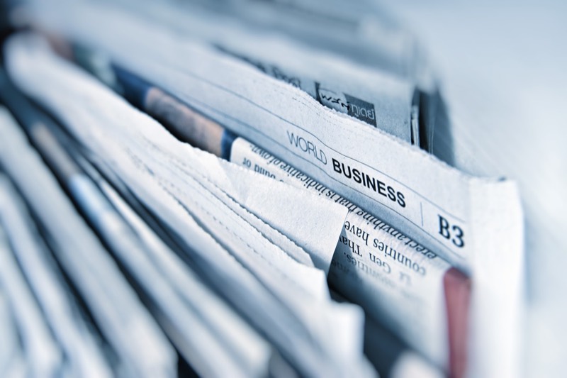 A stack of business newspapers