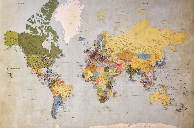 A world map marked with pins across every continent