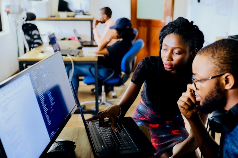 Two creators reviewing work together at a screen